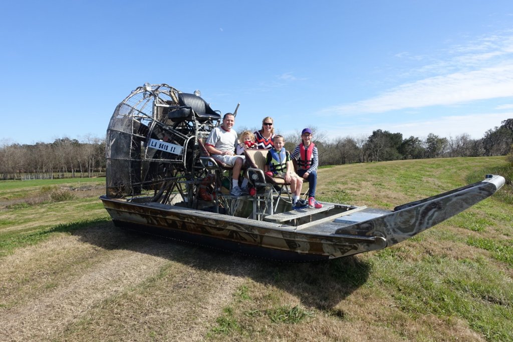 family sitting on an airboat