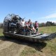 family sitting on an airboat