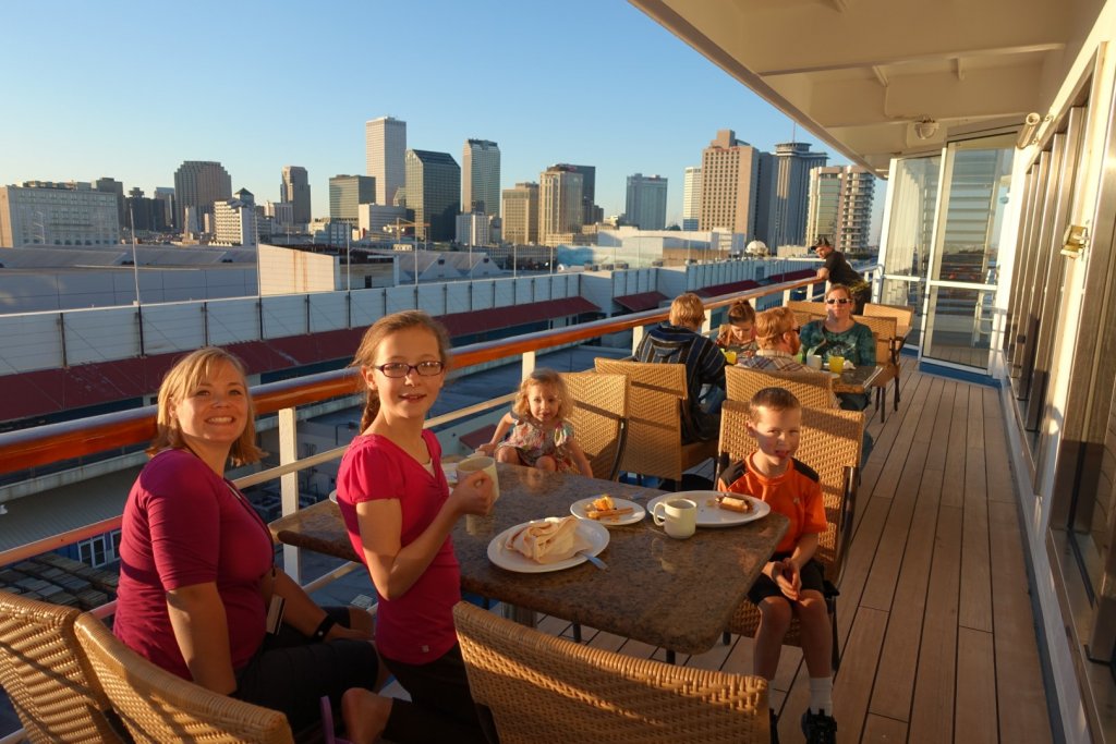 Family eating breakfast on cruise ship in port