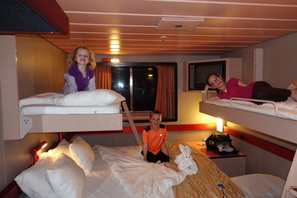 Kids on beds in stateroom on cruise ship