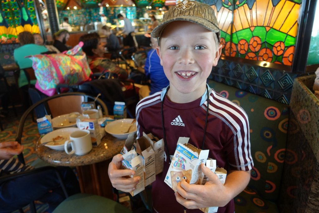 boy with lots of small cereal boxes