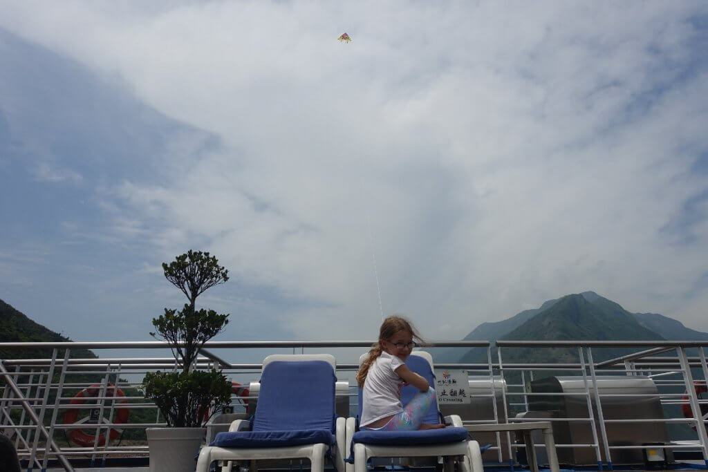 Flying a kite behind the ship