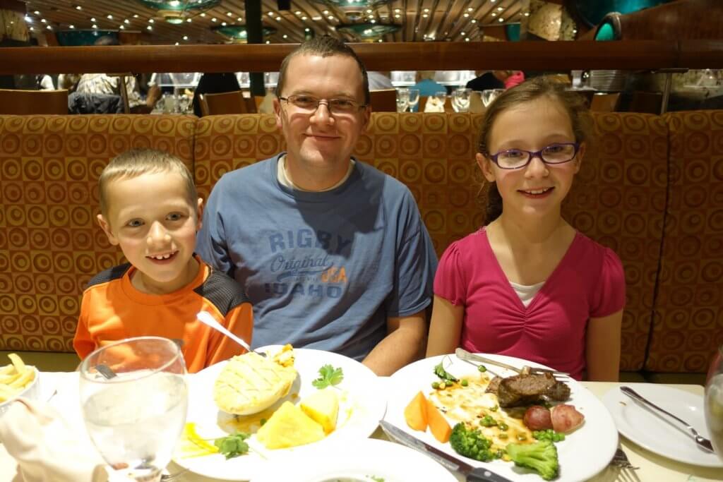 dad and kids with food on plates