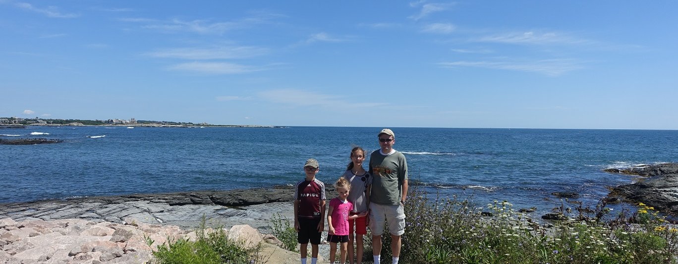 family in front of the ocean