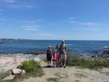 family in front of the ocean