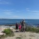 family in front of the ocean