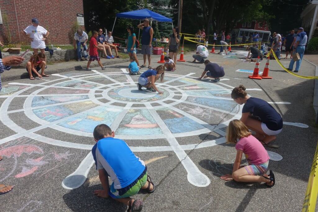 kids drawing with sidewalk chalk