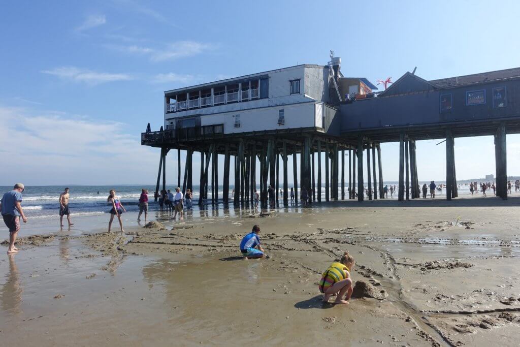 pier built up over a sandy beach