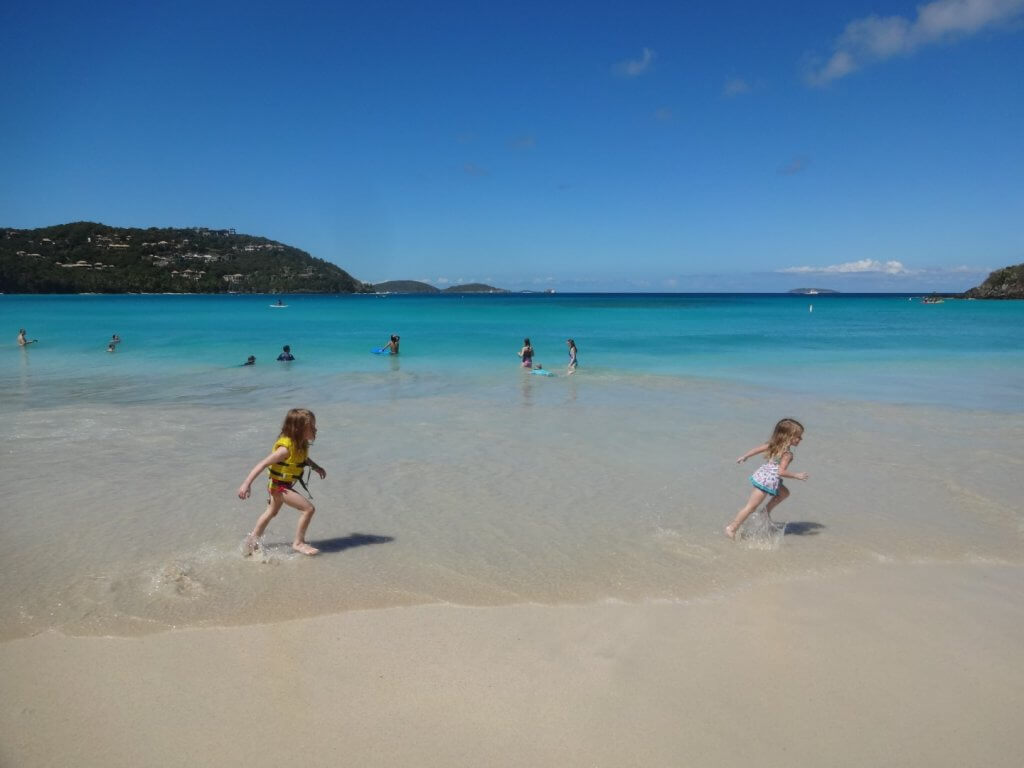 two girls running on a beach