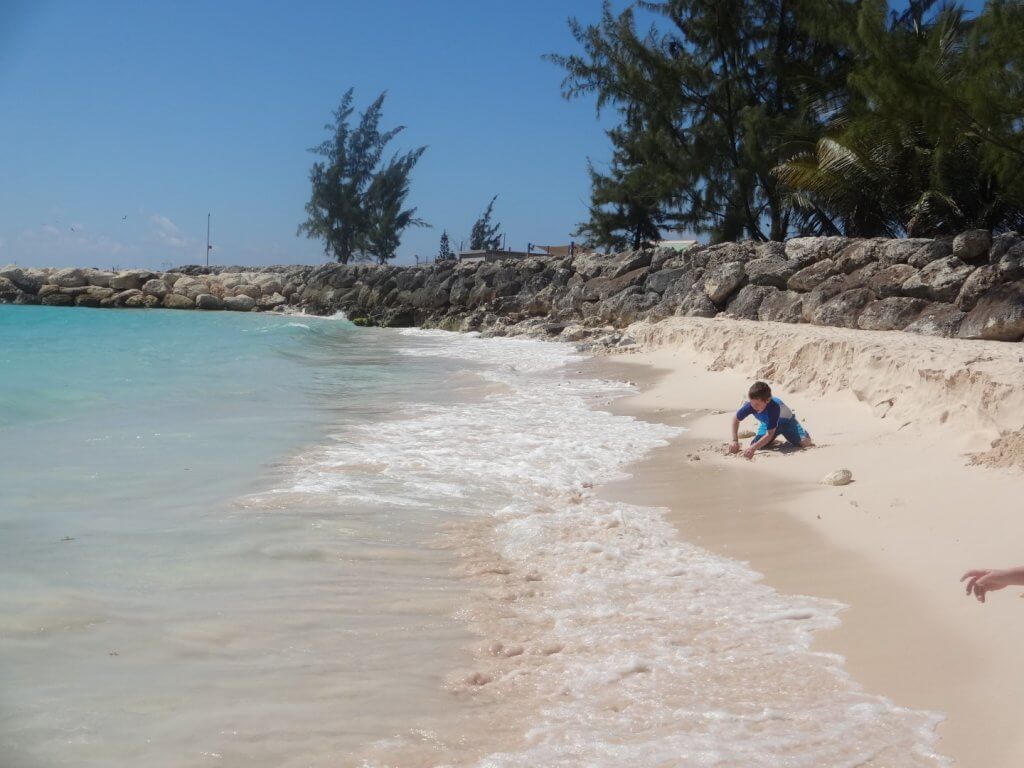 boy digging in the sand on the beach