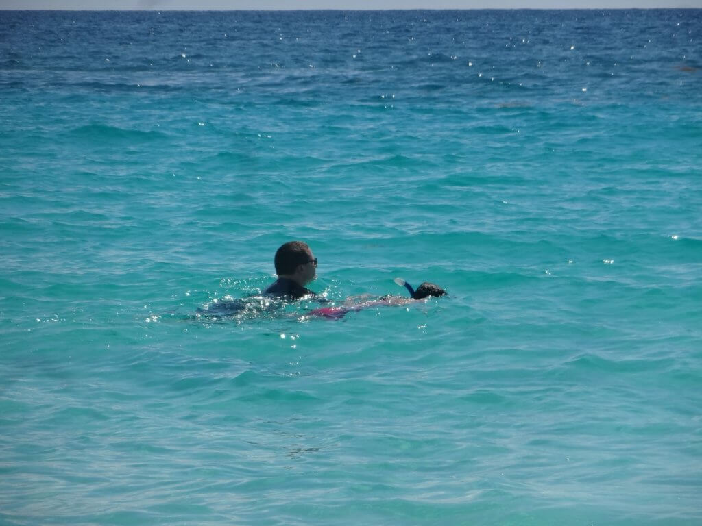 dad and daughter snorkeling in the ocean