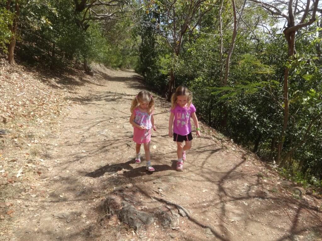 two girls walking on a path