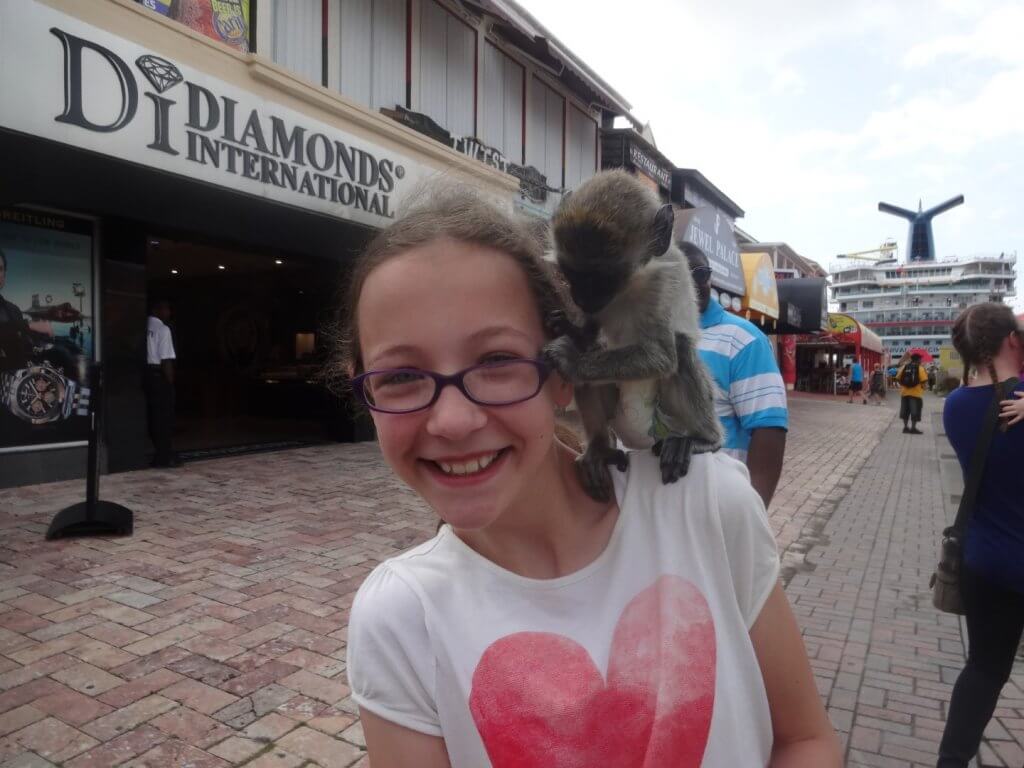 girl with a monkey on her shoulder