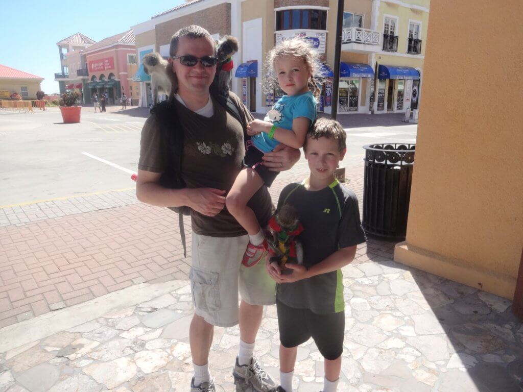 Dad and kids holding monkeys