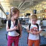 kids with backpacks in airport