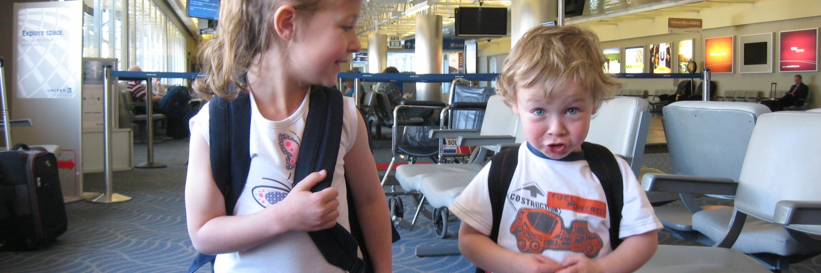 kids with backpacks in airport
