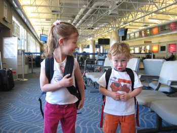 kids with backpacks in airport