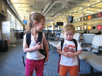 kids with backpacks in airport