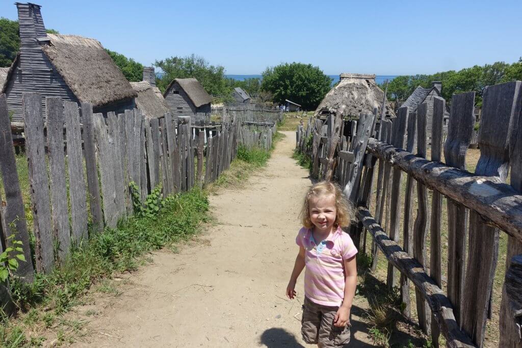 girl on a path with old buildings