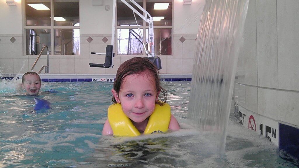 girl and boy in swimming pool