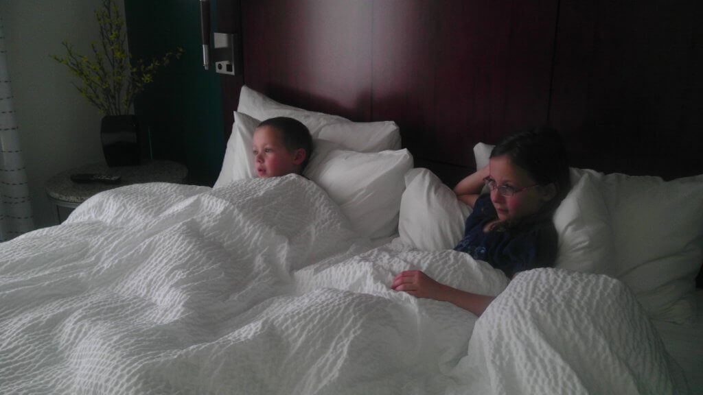 girl and boy in big bed