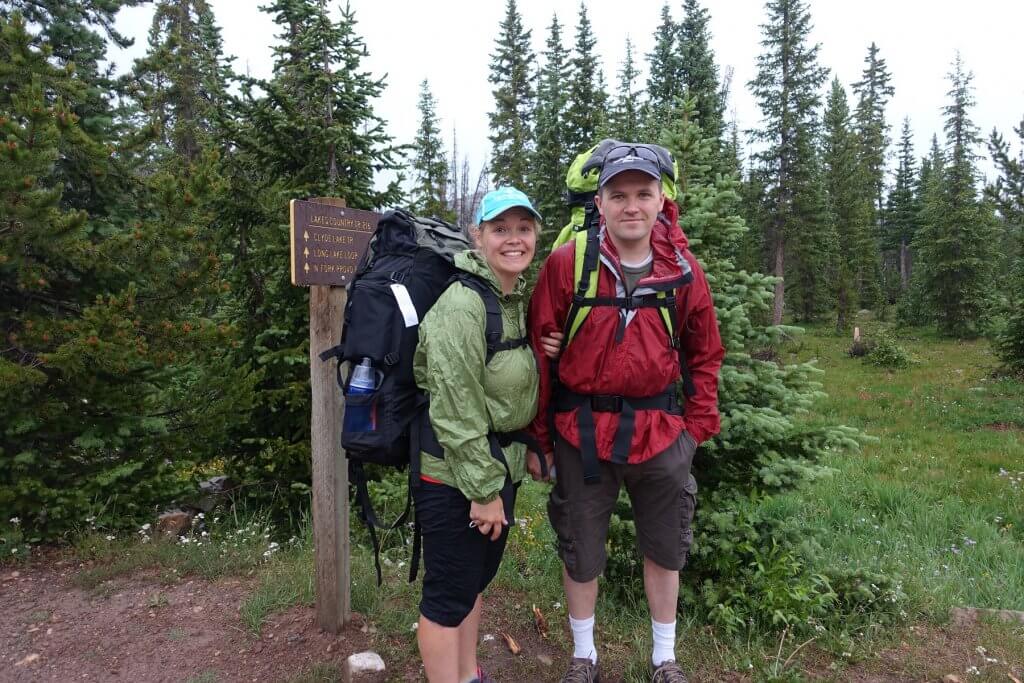 two adults with backpacking gear