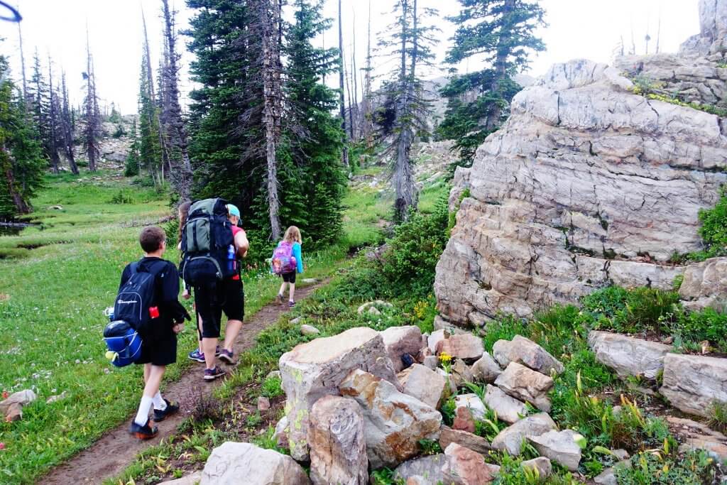 family hiking with backpacks