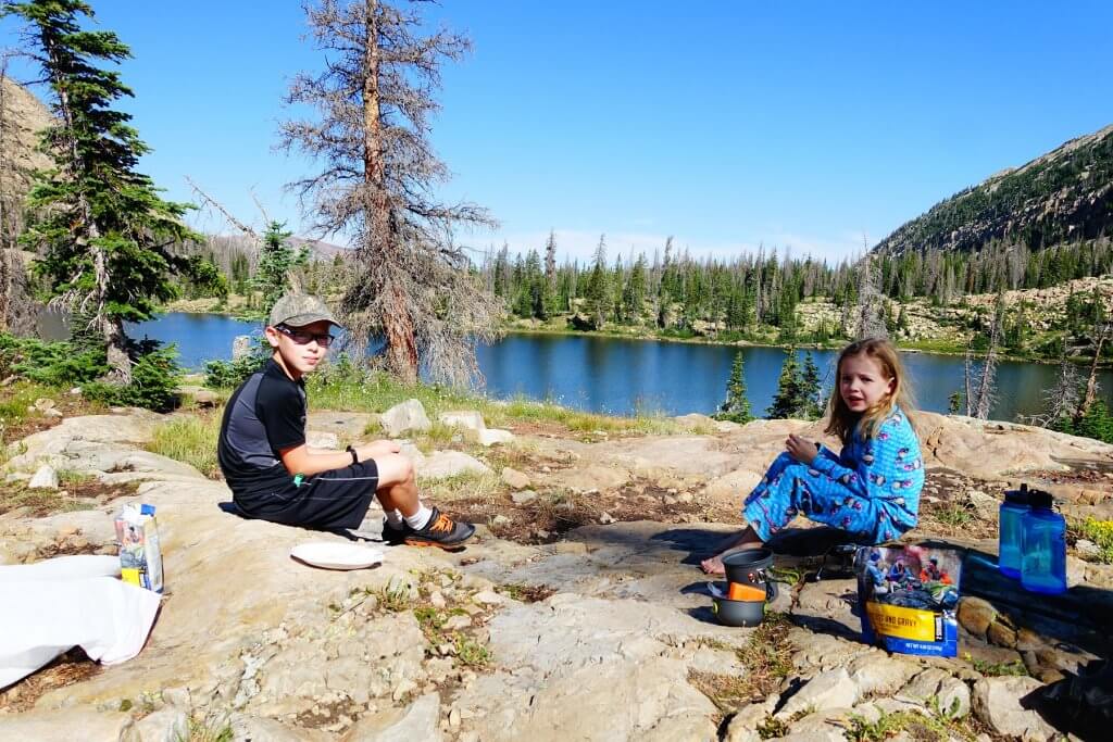 boy and girl sitting on rock