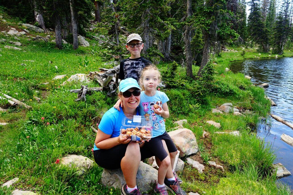 mom and kids with donuts in the mountains