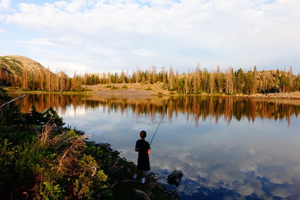 boy fishing in a lake