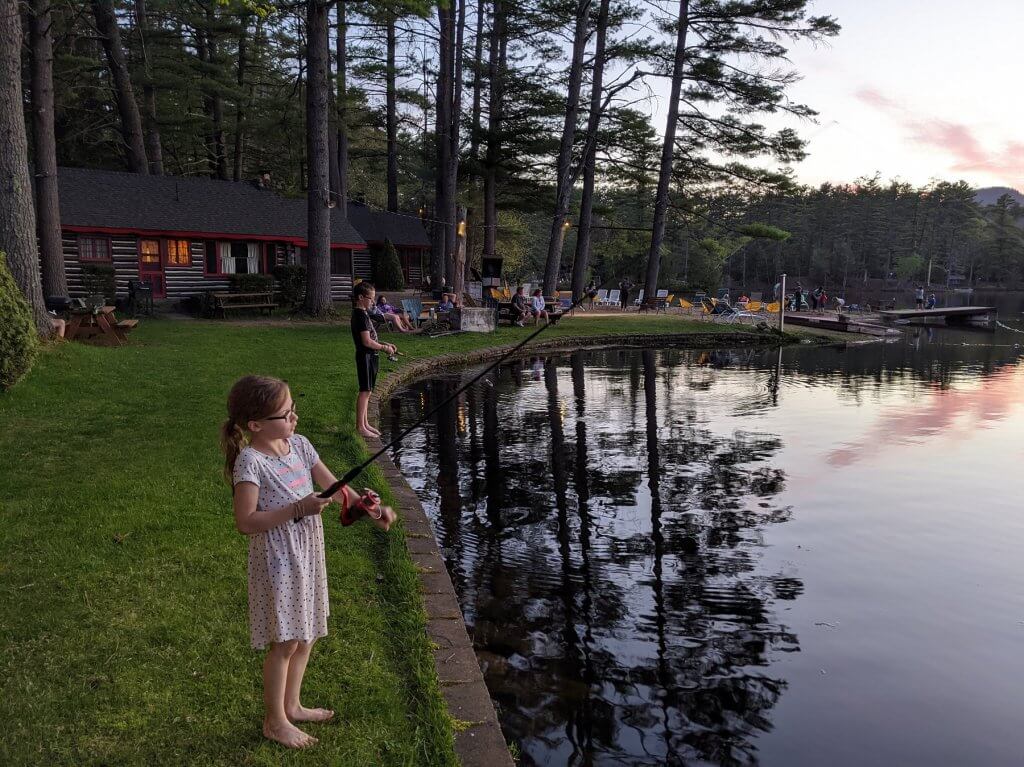 boy and girl fishing in a lake