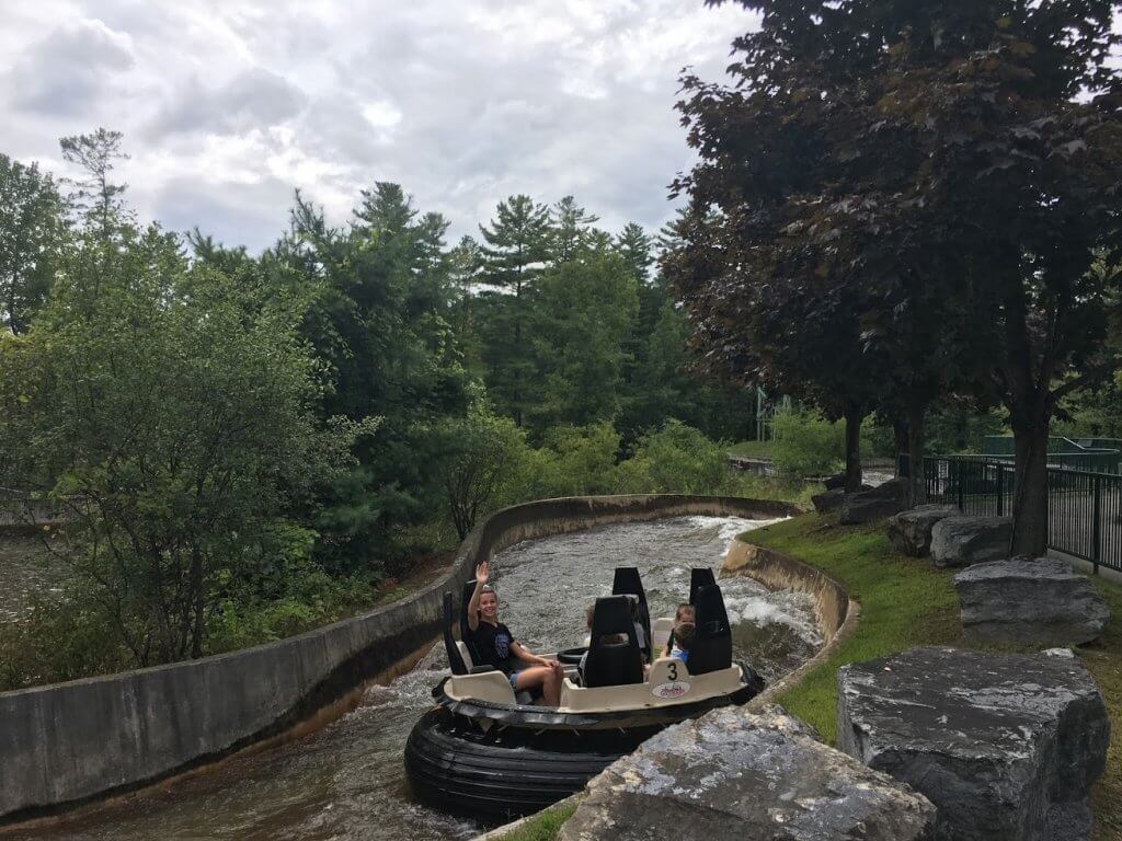 girl waving from a boat on river ride