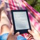 person reading from a tablet on a hammock