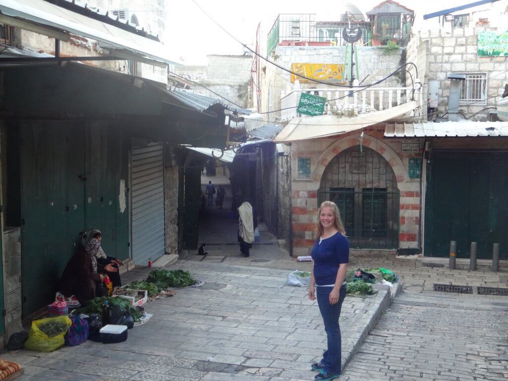 women in front of old town