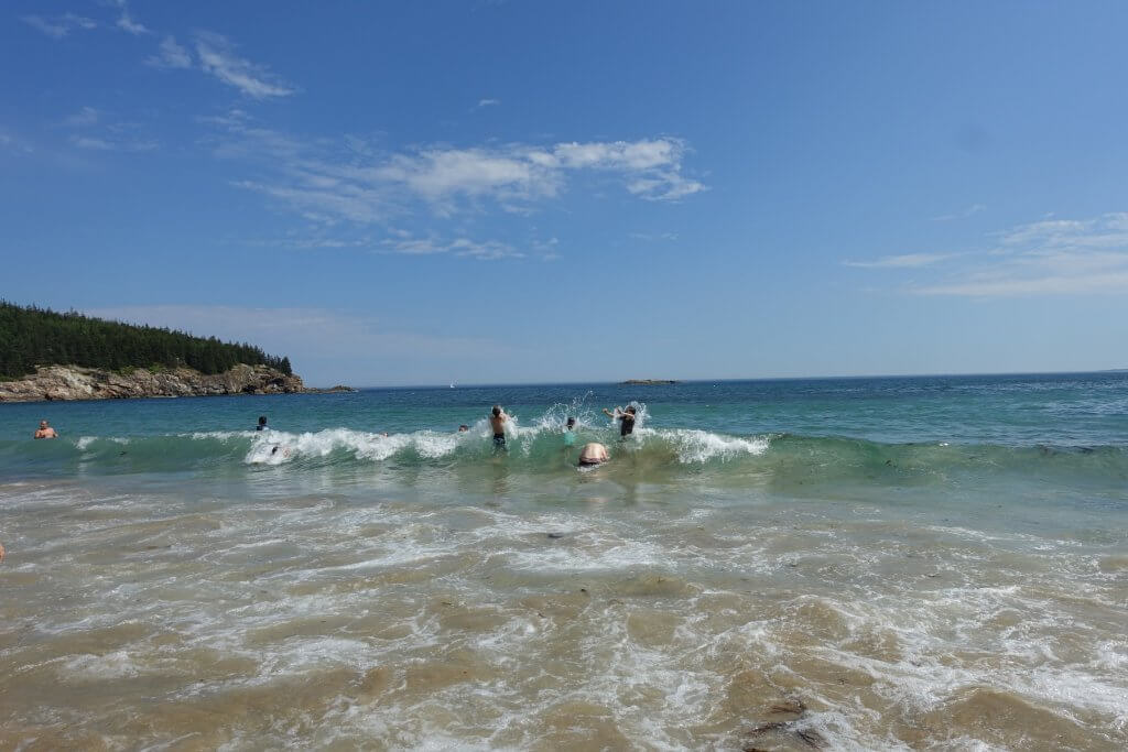 people playing in a wave