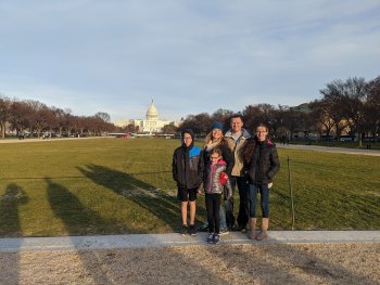 family in front of building