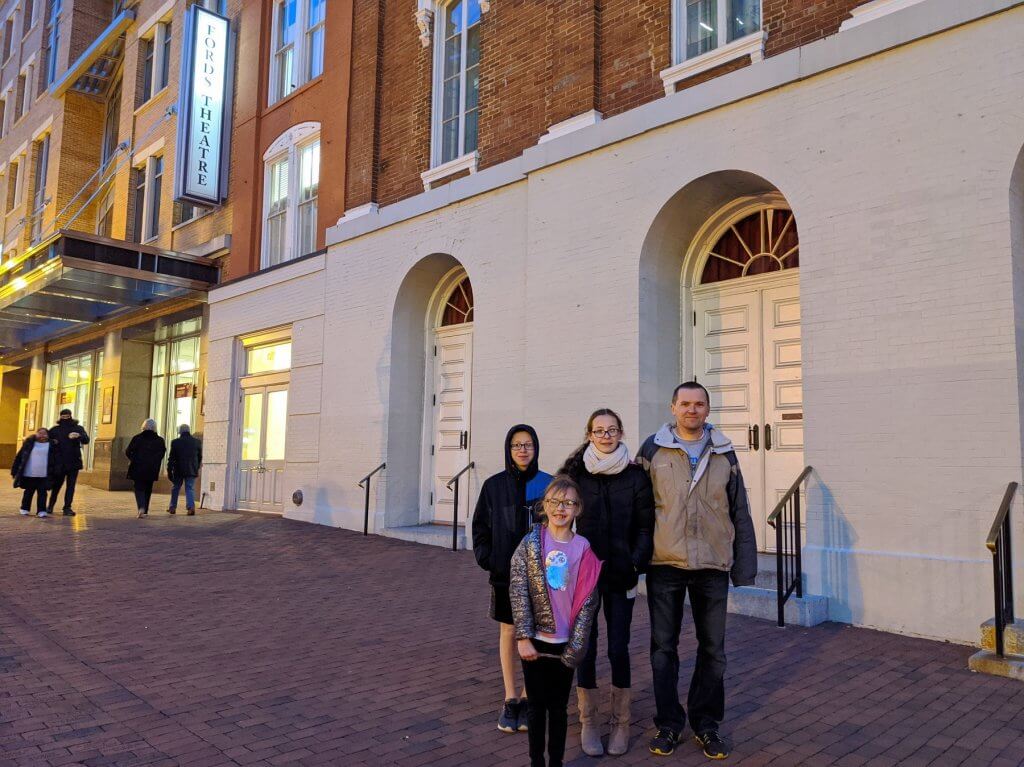 father and kids on a street