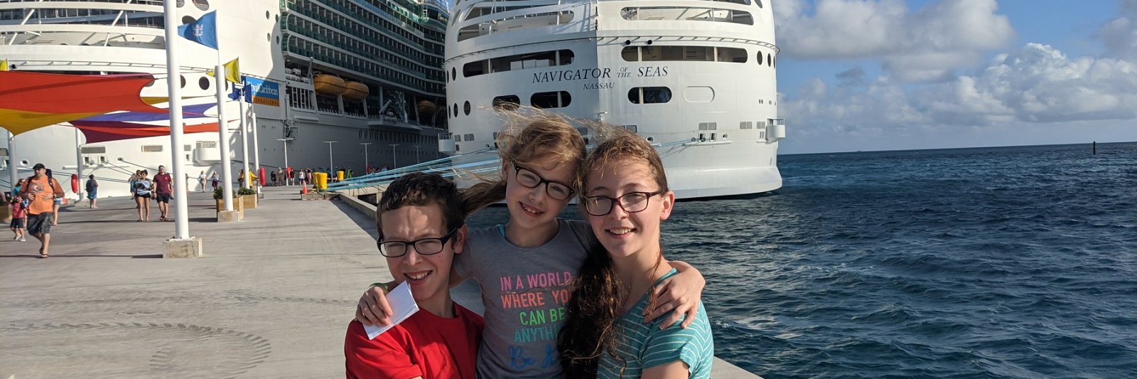 three kids in front of cruise ships