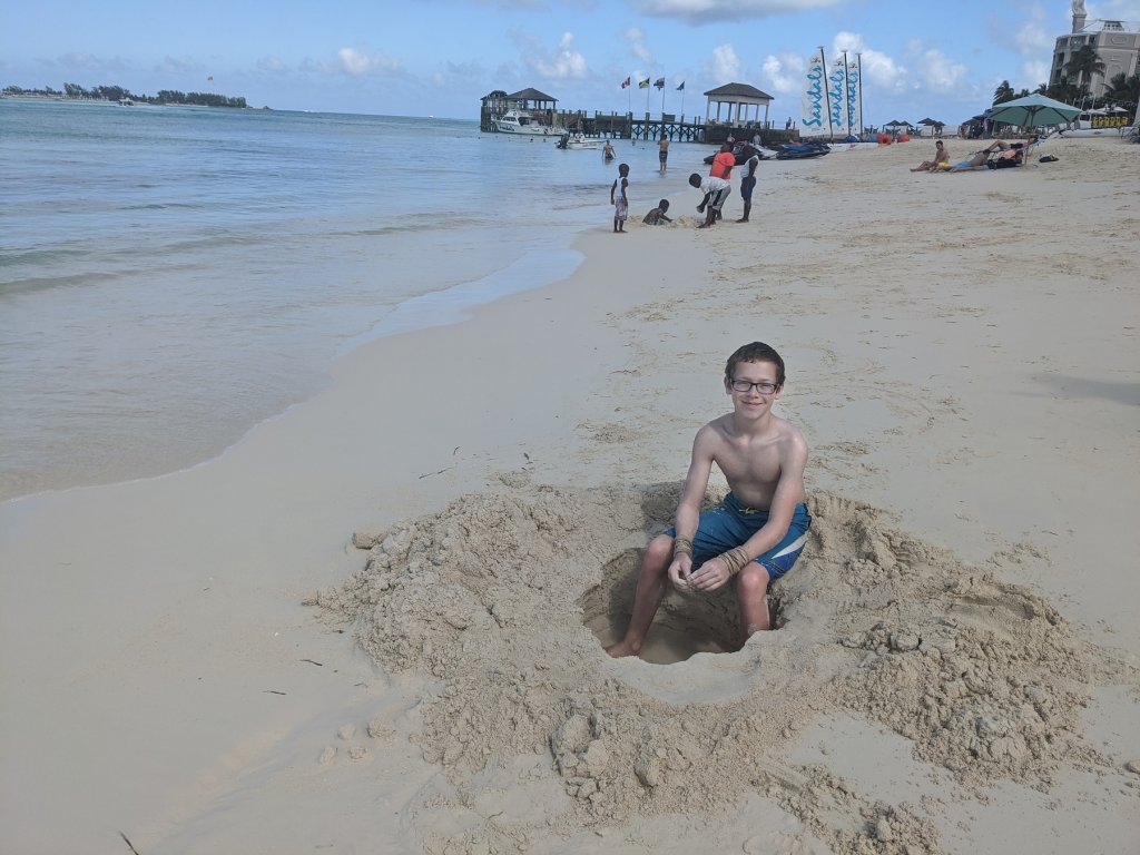 boy sitting on the sand