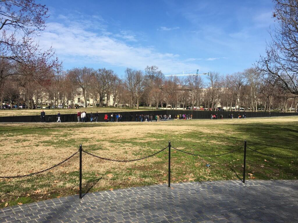 people looking at war memorial