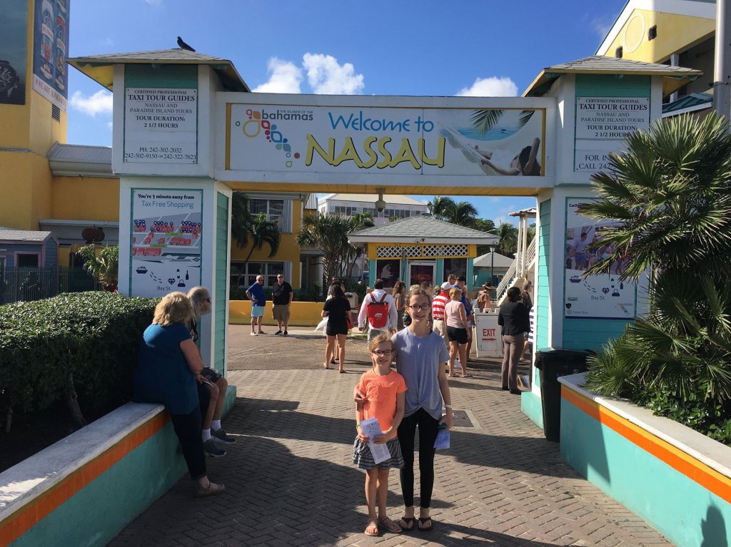 two girls in front of welcome sign