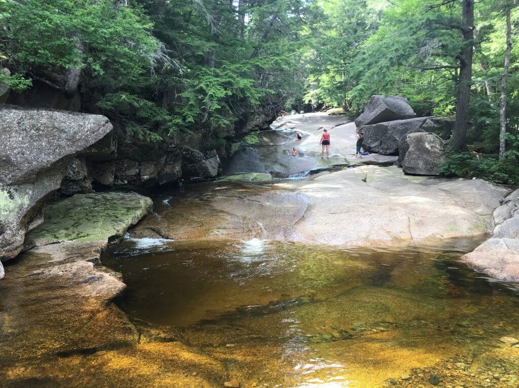 people sliding down rocks