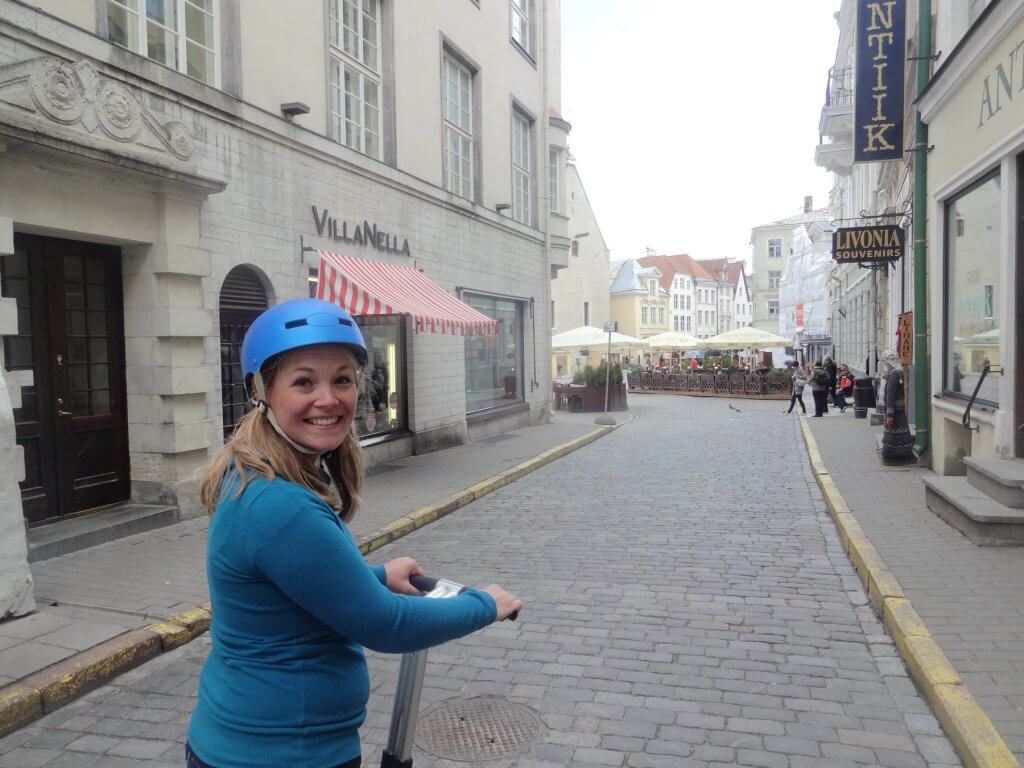 woman riding Segway on cobblestone road