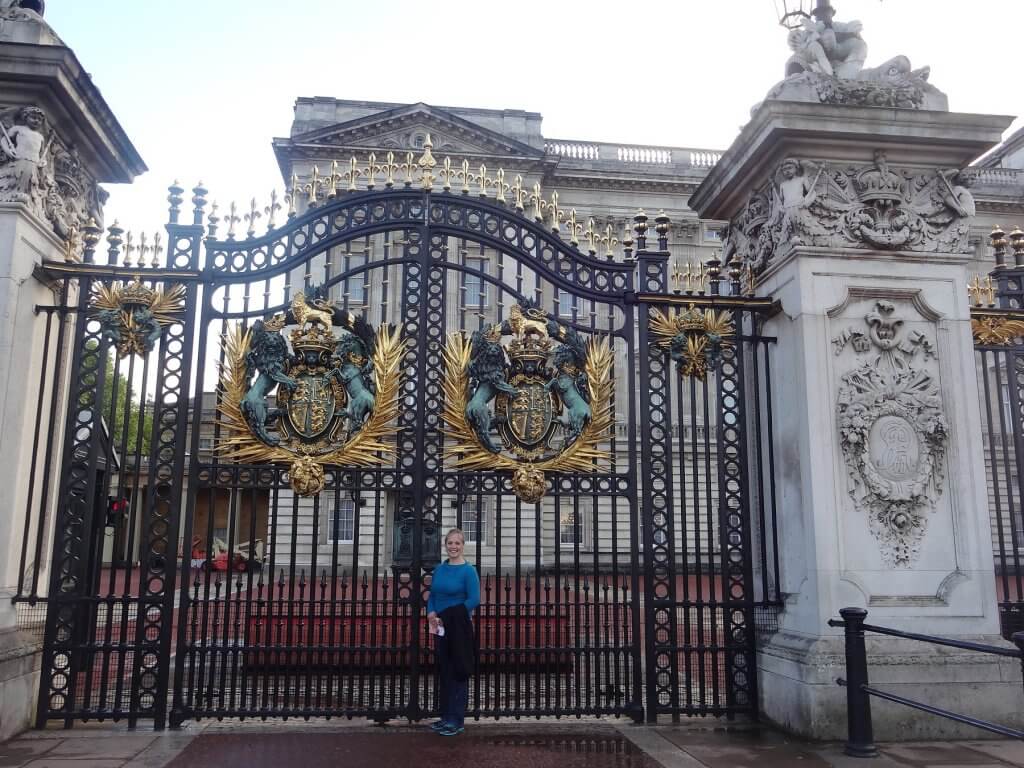 woman in front of gates to palace