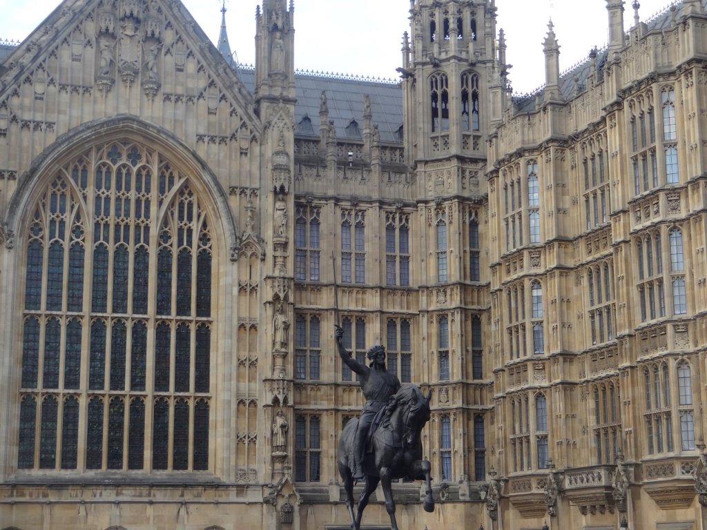 statue of man on a horse in front of building