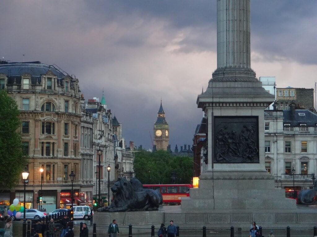 clock tower, lion statues, and tall pillar