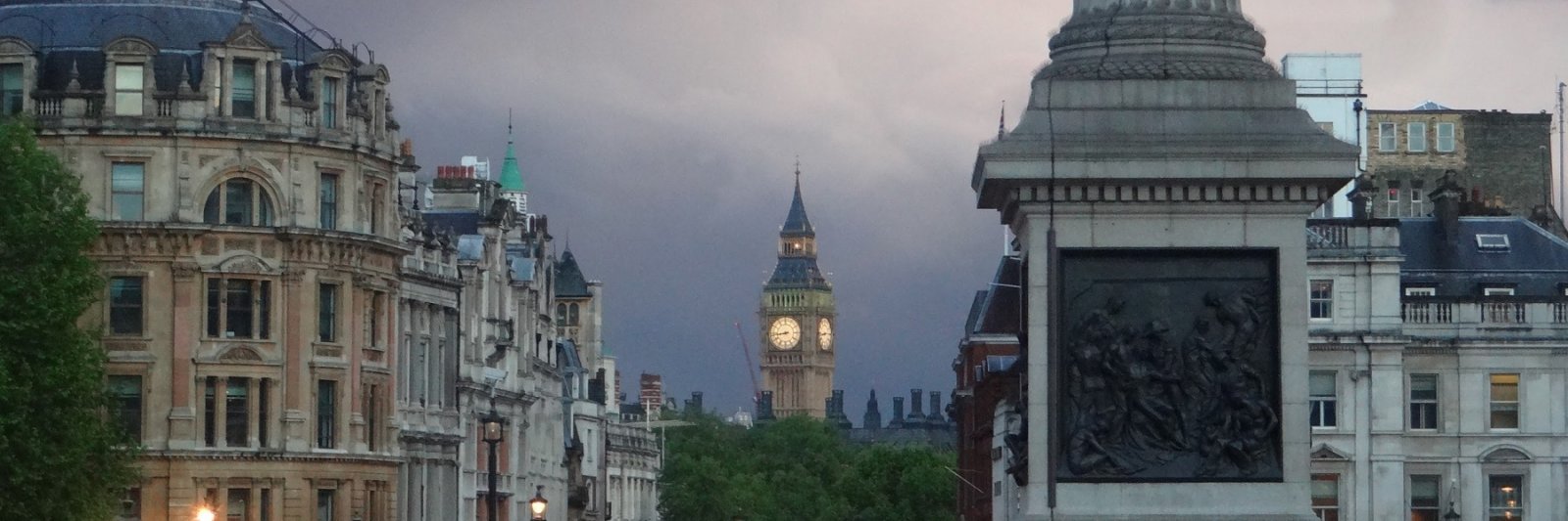 clock tower, lion statues, and tall pillar