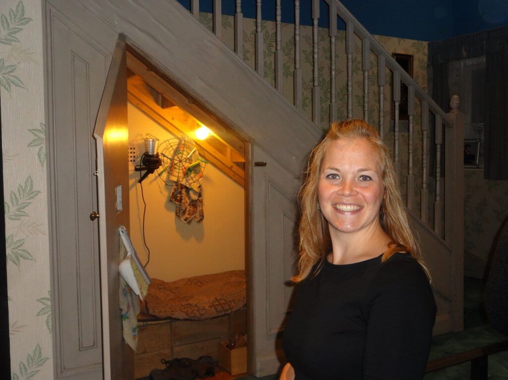 woman in front of a cupboard under the stairs