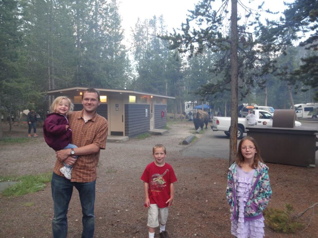 family at a campground with buffalo