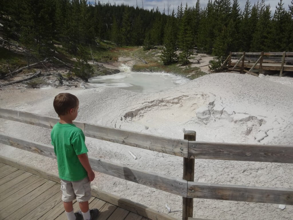 Boy watching mud pots